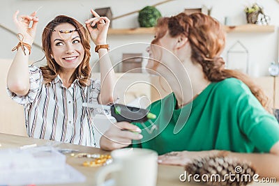 young women trying on handmade necklace Stock Photo