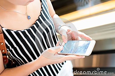 Young women using a mobile phone with texting message Stock Photo