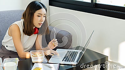 Young women work at home and eat meals during their work. Editorial Stock Photo