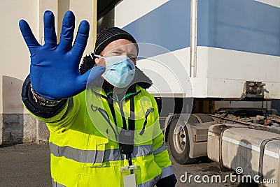 Young worker at express courier with Coronavirus protection mask Stock Photo