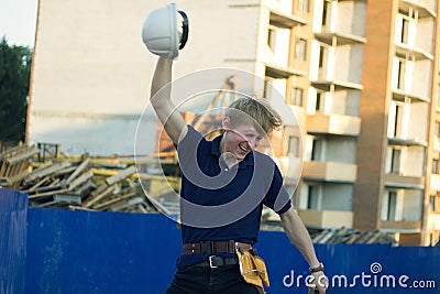 Young workman with helmet enjoy dancing while listening to music Stock Photo