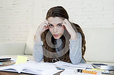 Young worried woman suffering stress doing domestic accounting paperwork bills Stock Photo