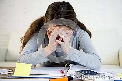 Young worried woman suffering stress doing domestic accounting paperwork bills Stock Photo