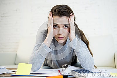 Young worried woman suffering stress doing domestic accounting paperwork bills Stock Photo