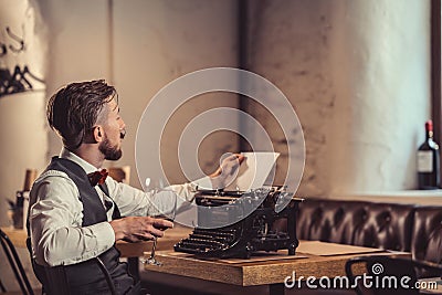 Young writer with a typewriter indoors Stock Photo