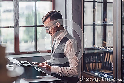 Young writer typing on a retro typewriter Stock Photo