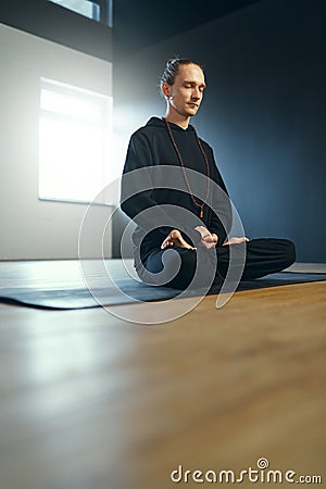 Young yogi man practicing meditation in lotus position. Stock Photo