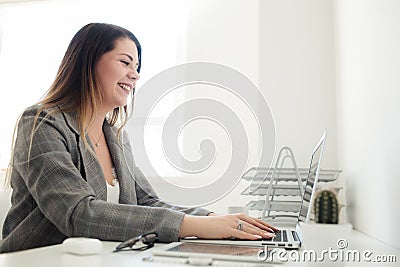 Younger girl working in the office at the table Stock Photo