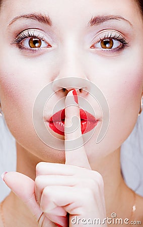 Young girl with finger by lips Stock Photo