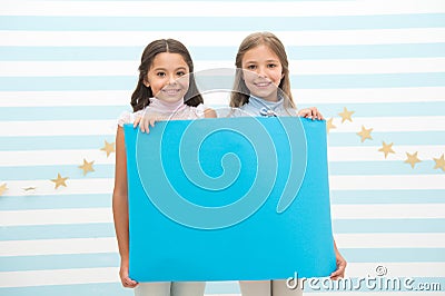 Your advertisement in good hands. Girls kids hold advertisement poster copy space. Children hold advertising banner Stock Photo