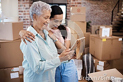 Your belongings might leave home but your heart never will. a senior woman looking at a photograph with her daughter Stock Photo