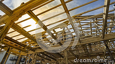 New residential construction house framing against a sunset Stock Photo