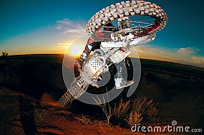 A motocrosser jumping at sunset Stock Photo