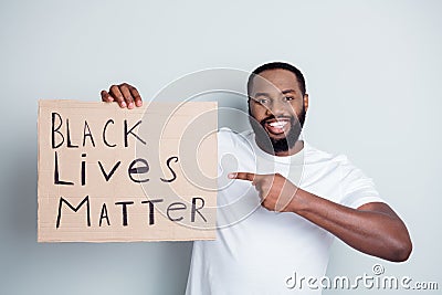 We are your friends. Photo of cheerful dark skin african protester direct finger placard against black citizens Editorial Stock Photo