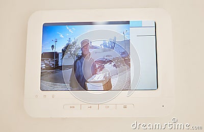 Your package has arrived. a young man on a tele screen delivering a package. Stock Photo