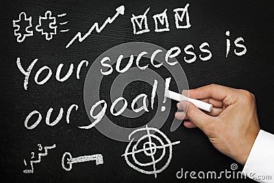 Your success is our goal. Blackboard or chalkboard with hand and chalk. Stock Photo