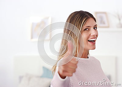 Youre awesome. an attractive woman showing thumbs up. Stock Photo