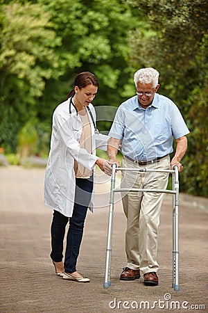 Youre doing great. a female doctor supporting her senior patient whos using a walker outside. Stock Photo