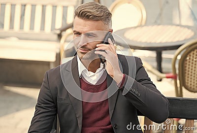 Youre never alone with cellphone. Businessman make phone call outdoors. Call answering. Phone conversation. Mobile Stock Photo