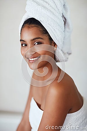 Youre worth your wellness. Portrait of an attractive and relaxed young woman wrapped in a towel at home. Stock Photo