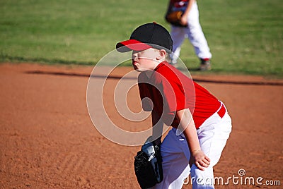 Youth baseball player hands on knees Stock Photo