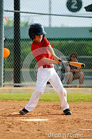 Youth baseball player swinging bat Stock Photo