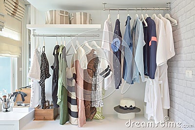 Youth cloths hanging in open wardrobe in bedroom Stock Photo