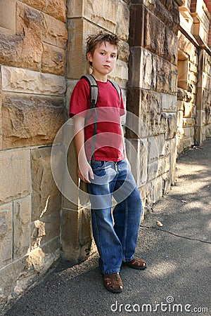 Youth leaning against wall Stock Photo
