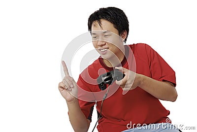 YOUTH LOOKING HAPPY AFTER SCORING ANOTHER POINT IN HIS ELECTRONIC GAME Stock Photo