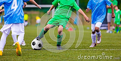 Youth soccer football teams kicking soccer ball on sports field Stock Photo