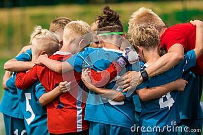 Youth sports coach witch children on soccer field. Kids huddling before the final tournament match Editorial Stock Photo