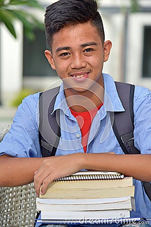 Youthful Filipino Boy Student Smiling With Notebooks Stock Photo