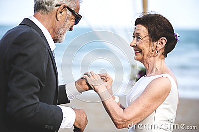 Youthful mature couple getting married at the beach Stock Photo