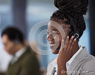 Youve called the right person. a young female call center agent working in an office. Stock Photo