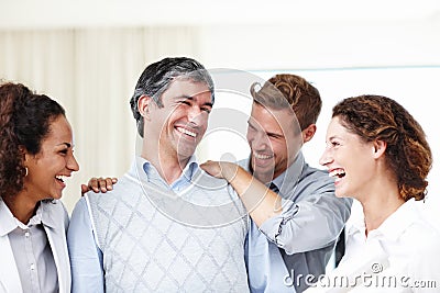 Youve done a great job. a group of positive young designers laughing together. Stock Photo