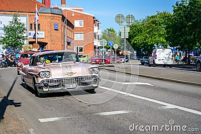 Ystad, Sweden - May 14 2019: Classic cars cruising in the city at Summer Meet . Lots of people standing on the side of the street Editorial Stock Photo