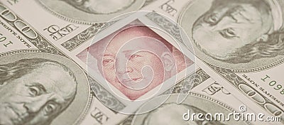 Yuan banknote, surrounded by 100 dollar bills. American market protectionism concept Stock Photo