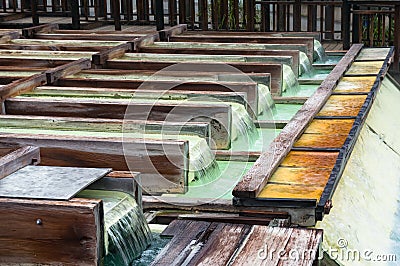 Yubatake onsen, hot spring wooden boxes with mineral water Stock Photo