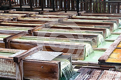 Yubatake onsen, hot spring wooden boxes with mineral water Stock Photo