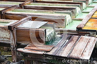 Yubatake onsen, hot spring wooden boxes with mineral water Stock Photo