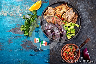 Yucatan Mexican Food Pork POC CHUC poc chuck. Pork marinaded in orange juice served with avocado, purple onion and Stock Photo