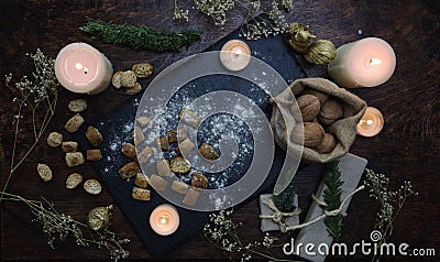 Yule winter solstice Christmas kitchen witchery. Preparation of festive food on dark wooden table. Stock Photo