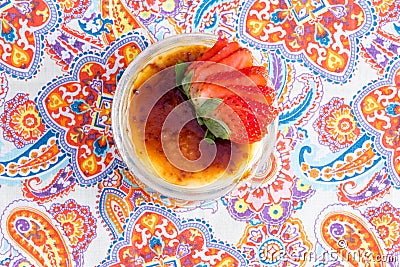 Yummy bowl of creme brulee with fresh strawberries Stock Photo