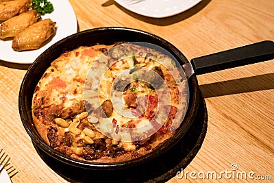 Yummy pan four portion pizza on the wooden table with grilled chicken Stock Photo