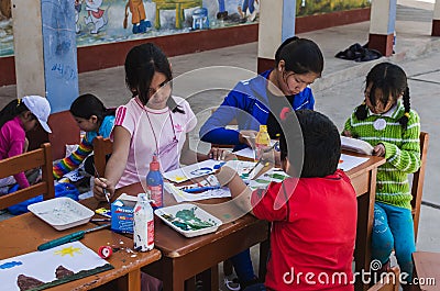 Yungay, Peru, August 8, 2014: group of girls and boy sitting at a table doing crafts with paint and brushes at school Editorial Stock Photo