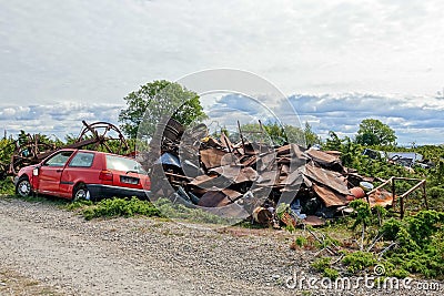 Yunk metal jardat the forest. metal trash. Huge pile of scrap metal with cloudy sky background Stock Photo