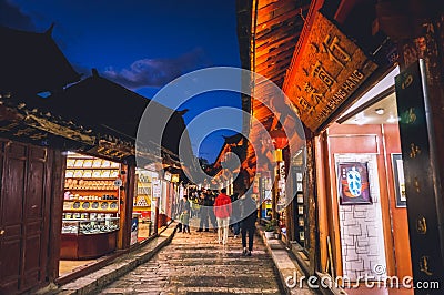 YUNNAN,CHINA 14 february 2022 - night scenic view of narrow street with souvenir shops in the Old Town of Lijiang Editorial Stock Photo