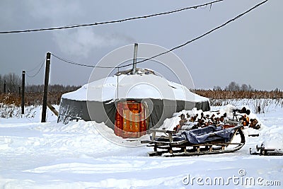 An yurt with the sleigh on a white snow. Stock Photo