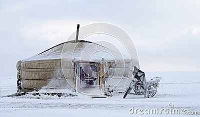 Yurt in the snow with a motorcycle in mongolia Stock Photo