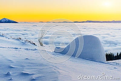 Yurt at sunset in winter fog mountains Stock Photo